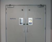 Paired hospital door set with vision panels.