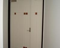 Uneven paired door set with feature panels.