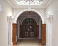 Heritage fire door with multiple vision panels and arched overlight.