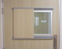 Formica faced hospital door set with vision panel and sliding privacy flap.