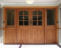 Heritage fire door set with raised bollection panels and glazed sidelights.